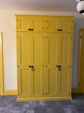 A shaker style large 4 door hall coat and shoe storage cupboard with wooden knobs.