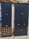 Two dark blue cabinets with wine rack on a wooden floor.