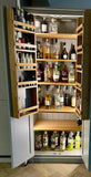 A 2-door cocktail/drinks cabinet with storage racks, fill with various bottles and shakers. The cabinet has a light wood finish and is open, revealing the interior shelving.