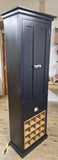 Dark wood cabinet with a wine rack on a wooden floor.