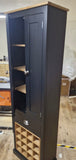 Tall dark blue cabinet with a wine rack on a wooden floor.
