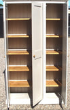 A traditional style solid pine wood storage cupboard withthree doors and a flat top, featuring wooden knobs and multiple internal shelves.