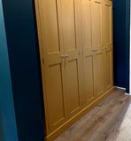 An India yellow 5-door hall coat and shoe storage cupboard with a top box and additional storage.