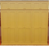 A indian yellow 6-door hall coat and shoe storage cupboard with a top box and additional storage.