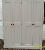 A large shaker style 4 door hallway coat and shoe, bootroom storage cupboard with wooden knobs.