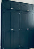 A blue style large 4 door hall coat and shoe storage cupboard with wooden knobs.