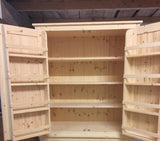 A large kitchen larder pantry cabinet with open doors, displaying wooden interior shelves and a wine rack, in a blue painted finish.